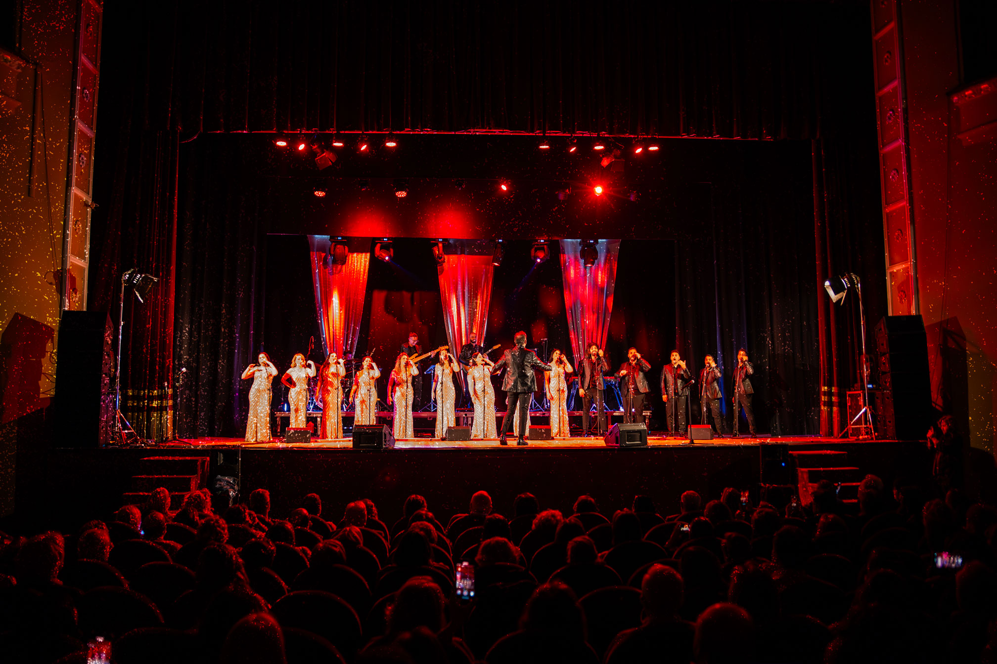Le voci di That’s Napoli sul palco, illuminate dalle luci del teatro